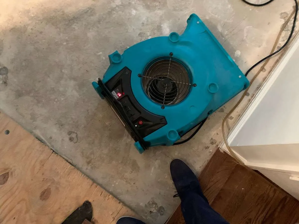 Air mover drying subfloor during Commercial Water Damage Restoration in Kailua-Kona